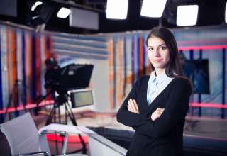 News writing and reporting.Woman journalist in television studio