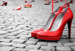 Red shoes to stop violence against women on a city square