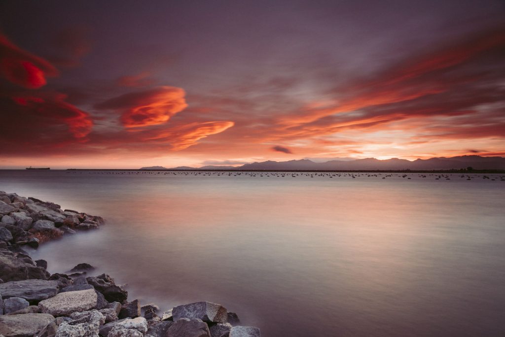 Rocks Near Body of Water During Sunset Wallpaper